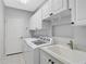 Convenient laundry room with washer, dryer, and cabinets at 4575 Cancello Grande Ave, Venice, FL 34293
