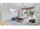 Bright living room features a comfy sofa, coffee table, and large windows at 4575 Cancello Grande Ave, Venice, FL 34293