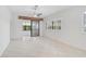 Bright and airy living room with tile floors and sliding doors at 4575 Cancello Grande Ave, Venice, FL 34293