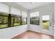 Sunroom with many windows and backyard access at 4575 Cancello Grande Ave, Venice, FL 34293