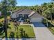 Single-story house with tile roof, landscaping, and a paved driveway at 498 Lake Of The Woods Dr, Venice, FL 34293
