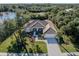 Single-story home with tile roof and lush landscaping near a waterway at 498 Lake Of The Woods Dr, Venice, FL 34293