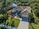 Single-story home with a tile roof, landscaped yard, and driveway at 498 Lake Of The Woods Dr, Venice, FL 34293