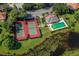 Aerial view showing tennis courts, pool, and clubhouse at 498 Lake Of The Woods Dr, Venice, FL 34293
