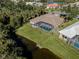 Aerial view showcasing home's pool and canal-side location at 498 Lake Of The Woods Dr, Venice, FL 34293