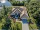 House with a pool and lush landscaping at 498 Lake Of The Woods Dr, Venice, FL 34293