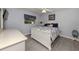 Guest bedroom with a white bed frame and gray tile floors at 498 Lake Of The Woods Dr, Venice, FL 34293