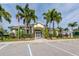 Community clubhouse with palm trees and parking at 498 Lake Of The Woods Dr, Venice, FL 34293
