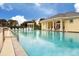 Resort-style community pool with a view of the clubhouse at 498 Lake Of The Woods Dr, Venice, FL 34293
