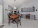 Bright dining area with wood table and chairs, built-in desk and cabinets at 498 Lake Of The Woods Dr, Venice, FL 34293