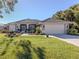 One-story house with a landscaped yard and attached garage at 498 Lake Of The Woods Dr, Venice, FL 34293
