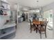 Open concept kitchen and dining area with a wooden table and gray cabinets at 498 Lake Of The Woods Dr, Venice, FL 34293
