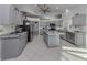 Spacious kitchen with gray cabinets, granite counters, and stainless steel appliances at 498 Lake Of The Woods Dr, Venice, FL 34293