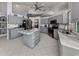 Modern kitchen featuring gray cabinetry, granite countertops, and an island at 498 Lake Of The Woods Dr, Venice, FL 34293