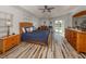 Main bedroom with wood furniture, a ceiling fan, and access to the pool at 498 Lake Of The Woods Dr, Venice, FL 34293