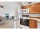 Bright kitchen features granite countertops and wood cabinets at 519 Albee Farm Rd # 115, Venice, FL 34285