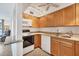 Kitchen with wood cabinets, granite counters and appliances at 519 Albee Farm Rd # 115, Venice, FL 34285