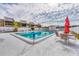 Relaxing community pool with patio furniture and umbrellas at 519 Albee Farm Rd # 115, Venice, FL 34285