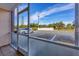 Screened porch with view of parking lot and surrounding area at 519 Albee Farm Rd # 115, Venice, FL 34285