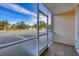 Screened-in porch overlooking the parking lot and some trees at 519 Albee Farm Rd # 115, Venice, FL 34285
