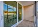 Sliding glass doors open to a view of the living room from this screened porch at 519 Albee Farm Rd # 115, Venice, FL 34285