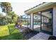 Landscaped backyard with pool, patio, and lush greenery at 521 Pennyroyal Pl, Venice, FL 34293