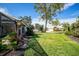 Expansive backyard showcasing lush landscaping and a tree at 521 Pennyroyal Pl, Venice, FL 34293