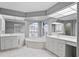 Elegant bathroom with double vanities, soaking tub, and separate shower at 521 Pennyroyal Pl, Venice, FL 34293