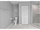 Bathroom with toilet, shower, and linen closet at 521 Pennyroyal Pl, Venice, FL 34293