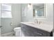 Modern bathroom with gray vanity and shower at 521 Pennyroyal Pl, Venice, FL 34293