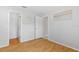 Light-filled bedroom featuring wood floors and a spacious closet at 521 Pennyroyal Pl, Venice, FL 34293
