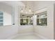 Cozy dining area with large windows and elegant chandelier at 521 Pennyroyal Pl, Venice, FL 34293