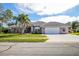 Single-story house with tile roof, two-car garage, and landscaped yard at 521 Pennyroyal Pl, Venice, FL 34293