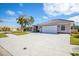 Property's front view showcasing a two-car garage and driveway at 521 Pennyroyal Pl, Venice, FL 34293