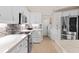 Modern kitchen with white cabinets, quartz countertops and stainless steel appliances at 521 Pennyroyal Pl, Venice, FL 34293