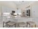 Spacious kitchen with island, white cabinets and stainless steel appliances at 521 Pennyroyal Pl, Venice, FL 34293