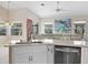 Modern kitchen with white cabinets, stainless steel appliances, and quartz countertops at 521 Pennyroyal Pl, Venice, FL 34293