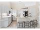 Modern kitchen with white cabinets, quartz countertops and stainless steel appliances at 521 Pennyroyal Pl, Venice, FL 34293