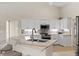 Modern kitchen with white cabinets, quartz countertops and stainless steel appliances at 521 Pennyroyal Pl, Venice, FL 34293