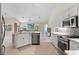 Open kitchen boasts stainless steel appliances and an island at 521 Pennyroyal Pl, Venice, FL 34293