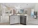 Modern kitchen with island, stainless steel appliances, and white cabinetry at 521 Pennyroyal Pl, Venice, FL 34293