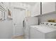 Convenient laundry room with washer, dryer, and cabinets at 521 Pennyroyal Pl, Venice, FL 34293