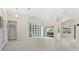 Open living space with light flooring and a view into kitchen at 521 Pennyroyal Pl, Venice, FL 34293