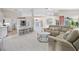 Spacious living room with open floor plan and kitchen views at 521 Pennyroyal Pl, Venice, FL 34293
