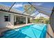 Relaxing pool area with covered patio and lush landscaping at 521 Pennyroyal Pl, Venice, FL 34293