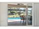 Enjoy the view from the sliding doors to the pool and patio area at 521 Pennyroyal Pl, Venice, FL 34293