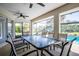 Covered patio with pool view, dining table, and seating at 521 Pennyroyal Pl, Venice, FL 34293