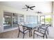 Spacious covered patio with glass-top table and seating at 521 Pennyroyal Pl, Venice, FL 34293