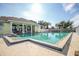 Community pool with adjacent patio and clubhouse at 521 Pennyroyal Pl, Venice, FL 34293
