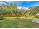 Spacious backyard with lush greenery and a patio area at 552 Fleetwood St, North Port, FL 34287